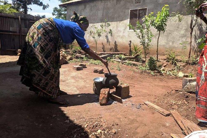 Private Market Tour and Tanzanian Cooking Class in Moshi - Inside the class: making coconut milk with a buzi and wood fire